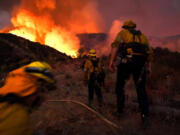 Firefighters make they their way up a hill as the El Dorado fire approaches in Yucaipa, California, on Sept. 1, 2020.