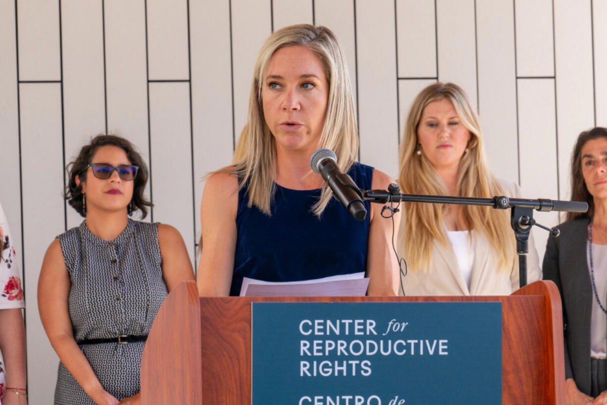 Amanda Zurawski, center, speaks during a press conference outside the Travis County Courthouse on Wednesday, July 19, 2023, in Austin, Texas. A Texas state court will hear arguments from both sides in Zurawski v. State of Texas, a lawsuit filed by the Center for Reproductive Rights on behalf of 13 Texas women denied abortions despite serious pregnancy complications.