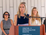 Amanda Zurawski, center, speaks during a press conference outside the Travis County Courthouse on Wednesday, July 19, 2023, in Austin, Texas. A Texas state court will hear arguments from both sides in Zurawski v. State of Texas, a lawsuit filed by the Center for Reproductive Rights on behalf of 13 Texas women denied abortions despite serious pregnancy complications.