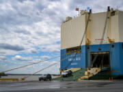 New Mitsubishis are driven off the Swan Ace vehicle carrier ship at Tradepoint Atlantic. The ship was supposed to unload at the Port of Baltimore, but was rerouted to Tradepoint following the collapse of the Francis Scott Key Bridge.