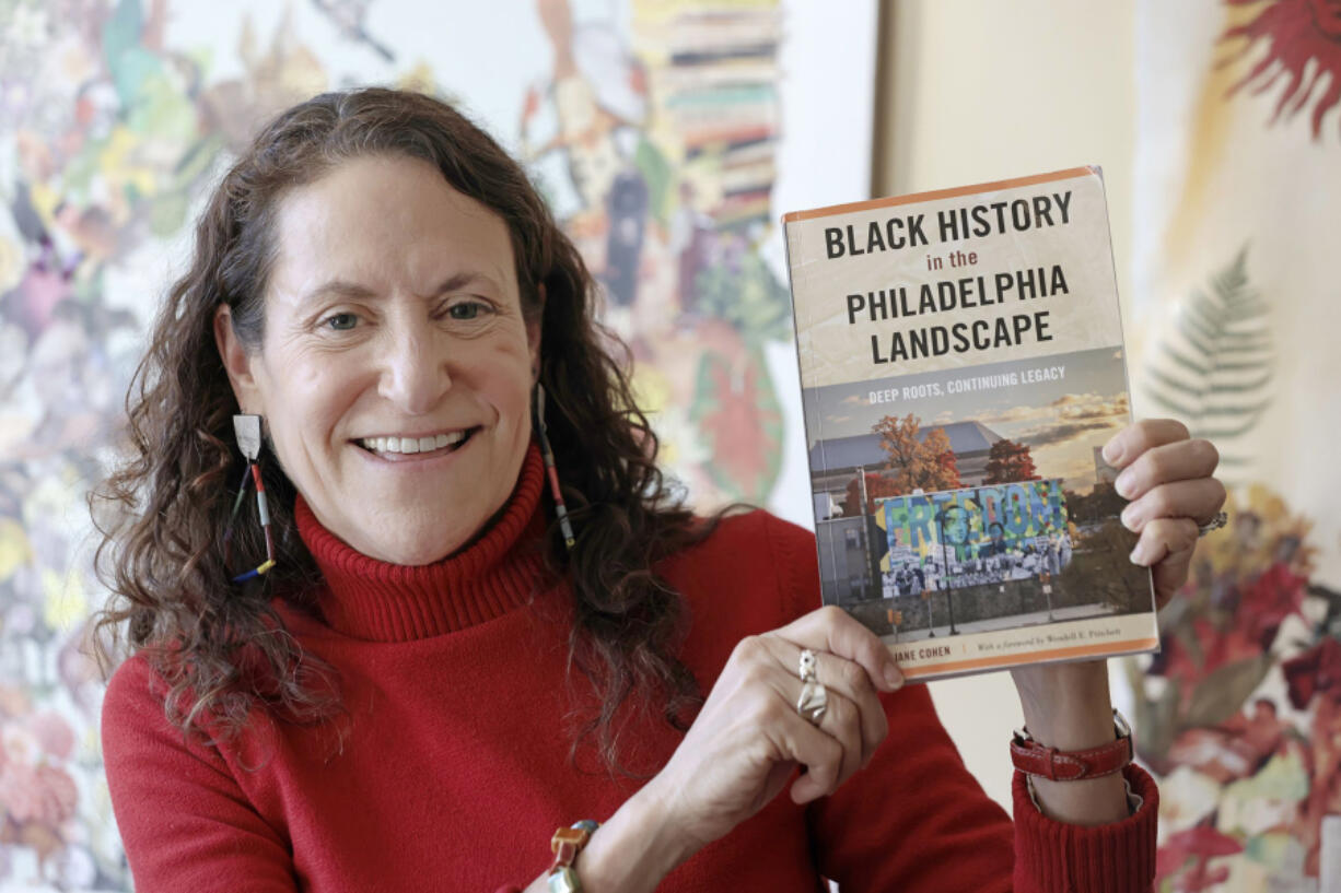 Amy Jane Cohen holds her book &ldquo;Black History in the Philadelphia Landscape&rdquo; at Cafe Walnut in Philadelphia.