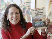 Amy Jane Cohen holds her book &ldquo;Black History in the Philadelphia Landscape&rdquo; at Cafe Walnut in Philadelphia.