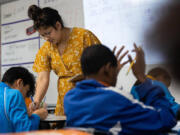 A teacher checks students&rsquo; work during class at IDEA Rise charter school on Nov. 10, 2022, in Fort Worth, Texas.