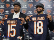 Chicago Bears No. 9 draft pick wide receiver Rome Odunze, left, and No. 1 draft pick quarterback Caleb Williams, right, hold up jerseys as they pose for a photo during an NFL football news conference in Lake Forest, Ill., Friday, April 26, 2024. (AP Photo/Nam Y.