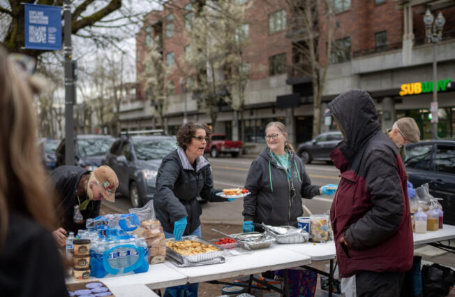 Free Hot Soup Vancouver volunteers Jennifer Wyld, from left, Becky Harrington and Ronda Hansen prepare a plate of food for a person at Esther Short Park in downtown Vancouver. The volunteers are part of a yearslong effort to help the hungry.