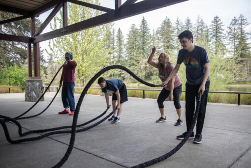 Mountain Tops class participants work on upper body strength by lifting and carrying kettle bells. At right,
Lacamas Lake Lodge has been an ideal place for Kiley Hauck, owner of Pacific Peaks Fitness, to blend exercise with getting outdoors, she said. (Amanda Cowan/The Columbian)