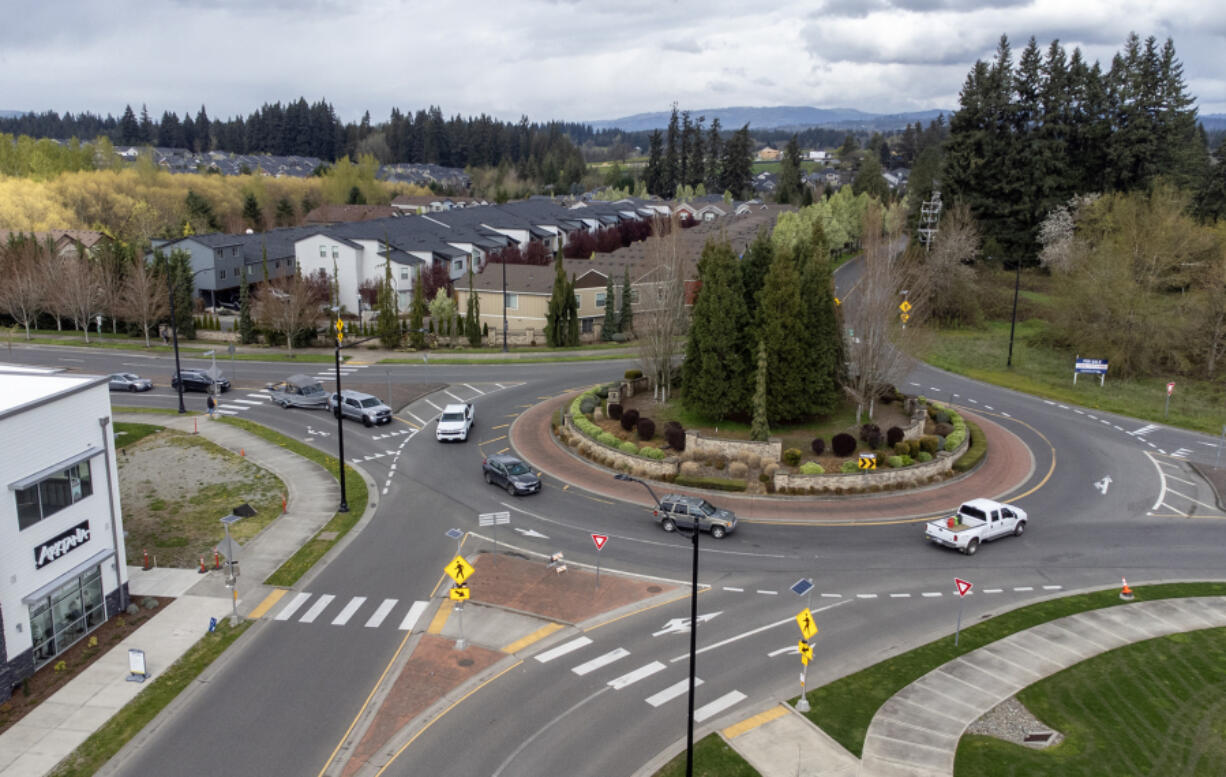 Cars drive around a roundabout Wednesday at Pioneer Street and Royle Road in Ridgefield.