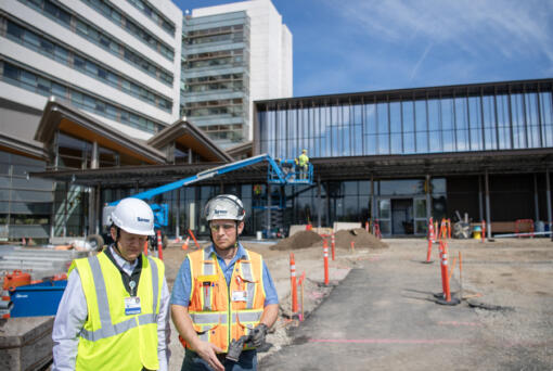 Dr. Jason Hanley, left, and site superintendent Joe Newman stand outside of a new emergency department building Friday at PeaceHealth Southwest Medical Center in Vancouver. The first section of the new emergency department is scheduled to open this summer.