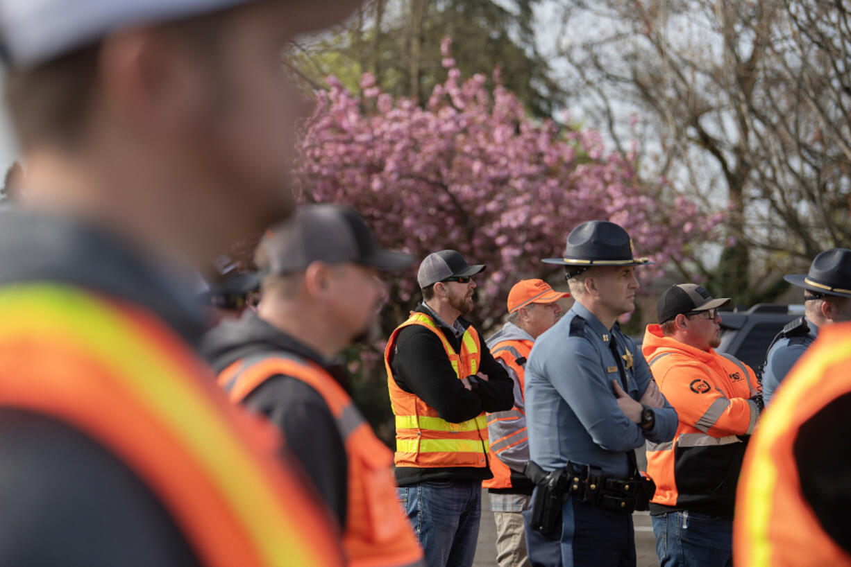 Members of the Washington State Department of Transportation and the Washington State Patrol gather to talk about work zone safety at the WSDOT Vancouver Maintenance Yard on Thursday morning.