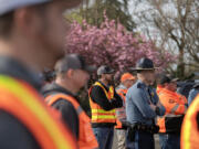 Members of the Washington State Department of Transportation and the Washington State Patrol gather to talk about work zone safety at the WSDOT Vancouver Maintenance Yard on Thursday morning.