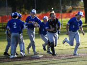 Members of the La Center baseball celebrate after beating Seton Catholic 8-4 in a Trico League game at Harmony Sports Complex on Friday, April 12, 2024.
