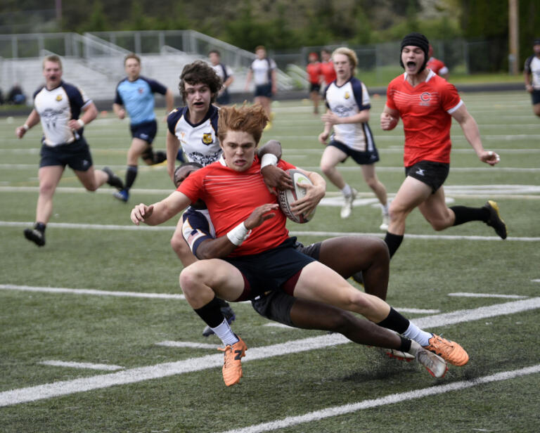 Cruz Williams of the Camas Rugby Club is tackled during a match against Budd Bay of Olympia at Doc Harris Stadium in Camas on Saturday, April 13, 2024.
