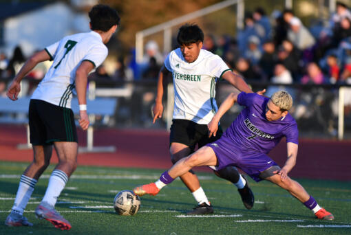 Heritage senior Marcos Tobar Martinez, right, pokes the ball away from Evergreen junior Juan Gomez-Rios on Friday, April 19, 2024, during the Timberwolves’ 3-1 win against Evergreen at Heritage High School.