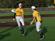 Evergreen players Joey Marin (7) and Ace Gutierrez celebrate the Plainsmen&rsquo;s 4-0 win over Kelso in a 3A Greater St. Helens League baseball game at Evergreen Sports Complex on Monday.