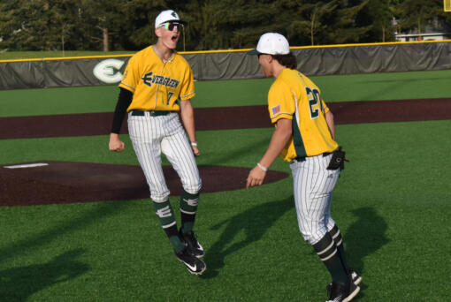 Evergreen players Joey Marin (7) and Ace Gutierrez celebrate the Plainsmen&rsquo;s 4-0 win over Kelso in a 3A Greater St. Helens League baseball game at Evergreen Sports Complex on Monday. (PHOTOS BY Tim Martinez/The Columbian)