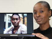 Fashion model Alexsandrah poses with a computer showing an AI generated image of her, in London, Friday, March 29, 2024. The use of computer-generated supermodels has complicated implications for diversity. Although AI modeling agencies -- some of them Black-owned -- can render models of all races, genders and sizes at the click of a finger, real models of color who have historically faced higher barriers to entry may be put out of work.