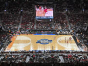 Texas and North Carolina State play during the second half of an Elite Eight college basketball game in the women's NCAA Tournament, Sunday, March 31, 2024, in Portland, Ore. The 3-point line for the women's NCAA Tournament at Moda Center had a discrepancy in distance at each end of the court that went unnoticed through four games over two days before Texas and North Carolina State were informed of the problem ahead of their Elite Eight matchup on Sunday.