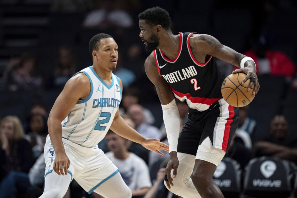 Charlotte Hornets forward Grant Williams (2) guards Portland Trail Blazers center Deandre Ayton (2) during the first half of an NBA basketball game Wednesday, April 3, 2024, in Charlotte, N.C.