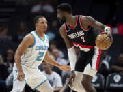 Charlotte Hornets forward Grant Williams (2) guards Portland Trail Blazers center Deandre Ayton (2) during the first half of an NBA basketball game Wednesday, April 3, 2024, in Charlotte, N.C.