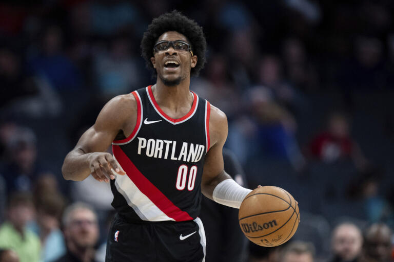 Portland Trail Blazers guard Scoot Henderson brings the ball upcourt during the second half of an NBA basketball game against the Charlotte Hornets Wednesday, April 3, 2024, in Charlotte, N.C.