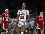 South Carolina guard Bree Hall (23) celebrates after making a three-point basket during the second half of a Final Four college basketball game against North Carolina State in the women's NCAA Tournament, Friday, April 5, 2024, in Cleveland.