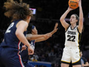 Iowa guard Caitlin Clark (22) shoots during the second half of a Final Four college basketball game against UConn in the women's NCAA Tournament, Friday, April 5, 2024, in Cleveland.