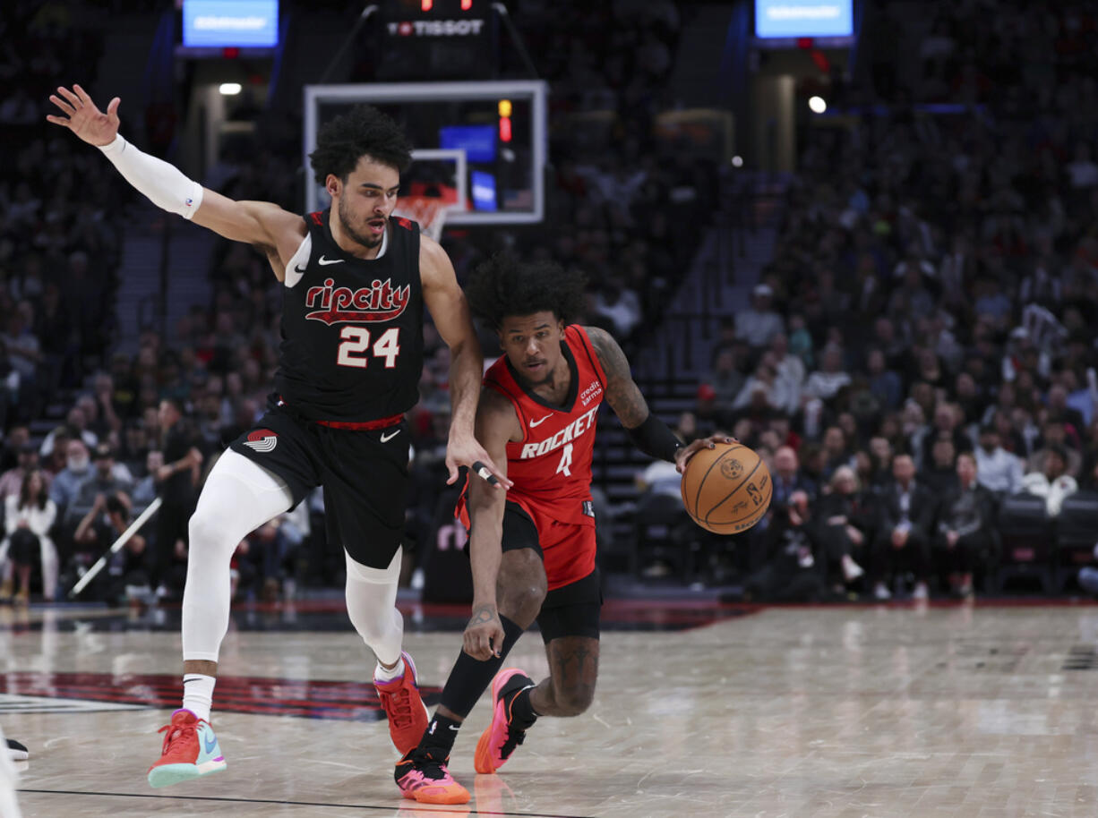 Houston Rockets guard Jalen Green, right, drives against Portland Trail Blazers forward Justin Minaya during the second half of an NBA basketball game Friday, April 12, 2024, in Portland, Ore.