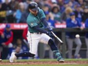 Seattle Mariners' Luis Urias hits an RBI double off Chicago Cubs starting pitcher Shota Imanaga during the second inning of a baseball game, Saturday, April 13, 2024, in Seattle.