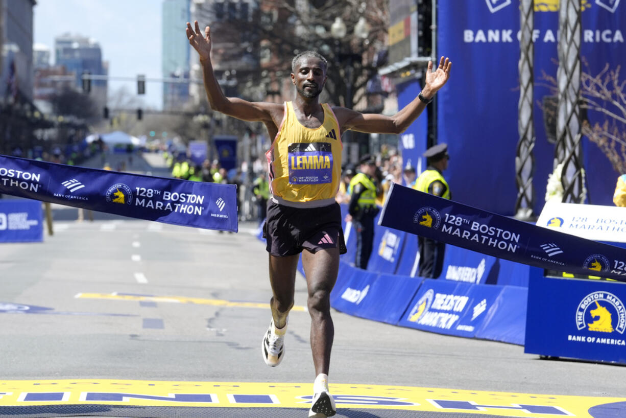 Sisay Lemma, of Ethiopia, breaks the tape to win the Boston Marathon, Monday, April 15, 2024, in Boston.