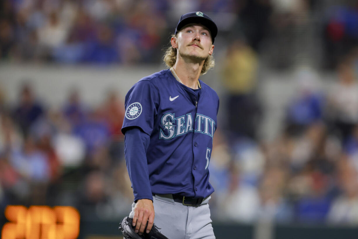 Seattle Mariners starting pitcher Bryce Miller walks to the dugout after the fourth inning of the team's baseball game against the Texas Rangers, Wednesday, April 24, 2024, in Arlington, Texas.