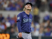 Seattle Mariners starting pitcher Bryce Miller walks to the dugout after the fourth inning of the team's baseball game against the Texas Rangers, Wednesday, April 24, 2024, in Arlington, Texas.