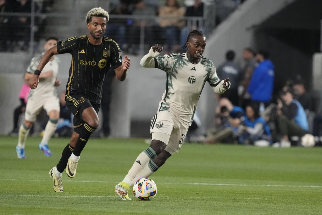 Portland Timbers midfielder Santiago Moreno (30) dribbles the ball past Los Angeles FC midfielder Timothy Tillman  during the second half of an MLS soccer match Saturday, April 27, 2024, in Los Angeles.