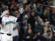 Seattle Mariners designated hitter Mitch Garver flips his bat after hitting a two-run walk-off home run against the Atlanta Braves during the ninth inning of a baseball game Monday, April 29, 2024, in Seattle. The Mariners won 2-1.