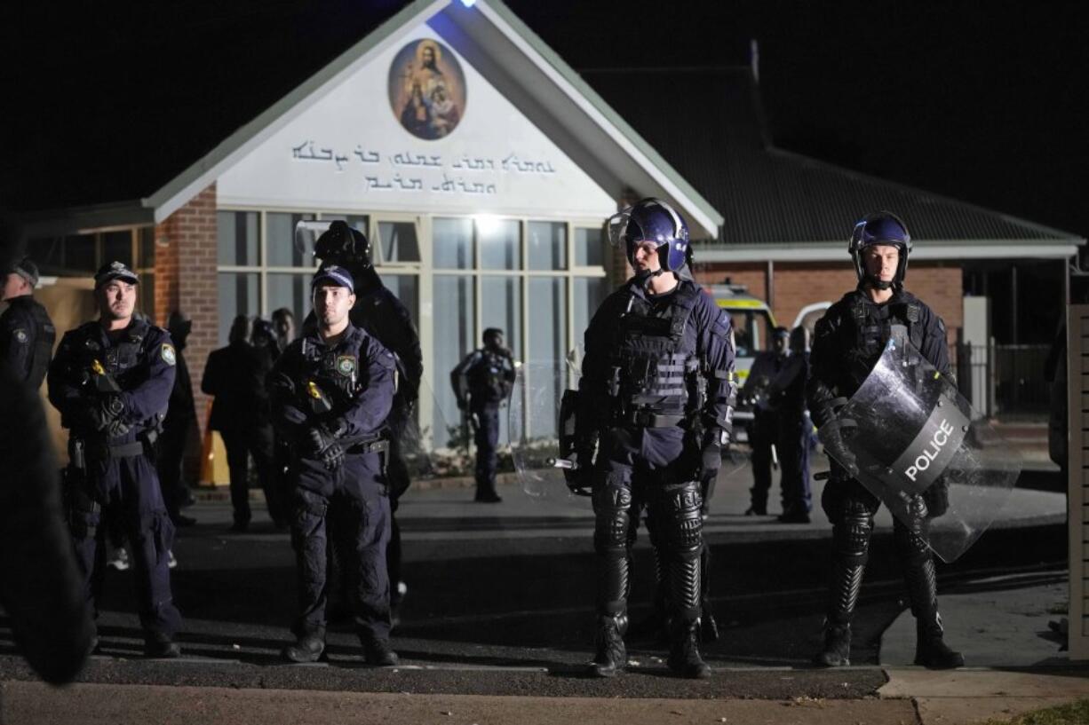 Security officers stand guard outside Orthodox Assyrian church in Sydney, Australia, Monday, April 15, 2024. Police in Australia say a man has been arrested after a bishop and churchgoers were stabbed in the church. There are no life-threatening injuries.