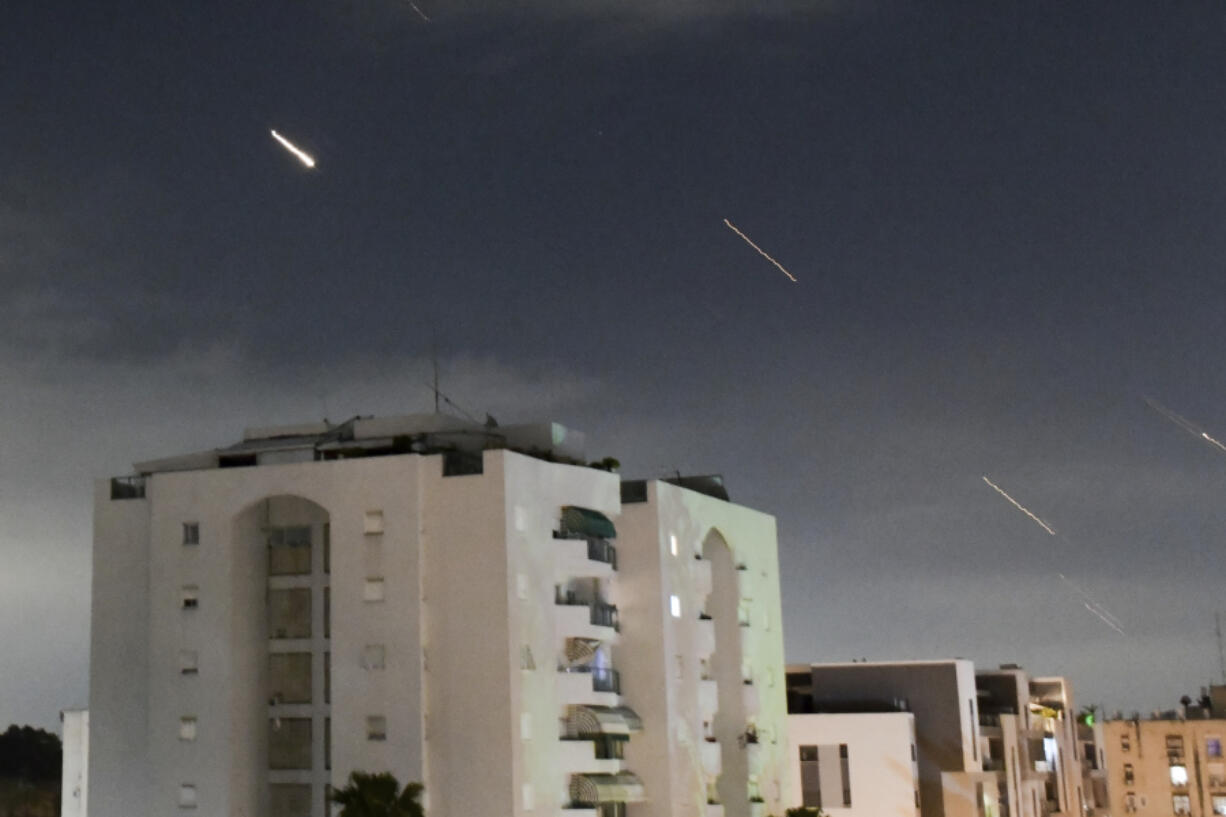 The Israeli Iron Dome air defense system launches to intercept missiles fired from Iran on Sunday in central Israel.