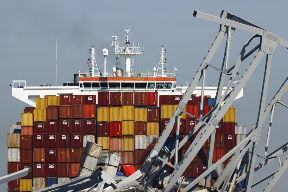 People are seen aboard the container ship Dali, Monday, April 15, 2024, in Baltimore. The FBI confirmed that agents were aboard the Dali conducting court-authorized law enforcement activity.