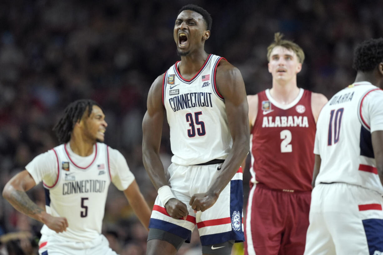 UConn forward Samson Johnson celebrates a basket during the second half of the NCAA college basketball game against Alabama at the Final Four, Saturday, April 6, 2024, in Glendale, Ariz.