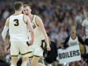 Purdue guard Fletcher Loyer (2) celebrates with guard Braden Smith (3) after scoring against North Carolina State during the second half of the NCAA college basketball game at the Final Four, Saturday, April 6, 2024, in Glendale, Ariz. (AP Photo/David J.