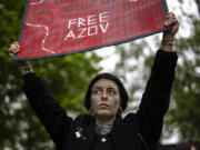 A woman holds a &quot;Free Azov&quot; sign during a rally aiming to raise awareness on the fate of Ukrainian prisoners of war in Kyiv, Ukraine, Sunday, April 21, 2024. The U.S. House of Representatives swiftly approved $95 billion in foreign aid for Ukraine, Israel and other U.S. allies in a rare Saturday session as Democrats and Republicans banded together after months of hard-right resistance over renewed American support for repelling Russia&#039;s invasion.