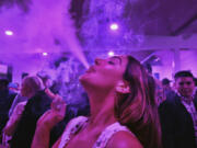 FILE - A guest takes a puff from a marijuana cigarette at the Sensi Magazine party celebrating the 420 holiday in the Bel Air section of Los Angeles, April 20, 2019. Marijuana advocates are gearing up for Saturday, April 20, 2024. Known as 4/20, marijuana&#039;s high holiday is marked by large crowds gathering in parks, at festivals and on college campuses to smoke together. This year, activists can reflect on how far the movement has come.