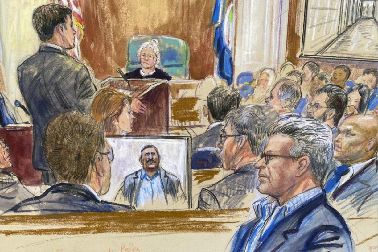 This artist sketch depicts Salah Al-Ejaili, foreground right with glasses, a former Al-Jazeera journalist, before the U.S. District Court in Alexandria, Va., Tuesday, April 16, 2024.  Al-Ejaili, a former detainee at the infamous Abu Ghraib prison, has described to jurors the type of abuse that is reminiscent of the scandal that erupted there 20 years ago: beatings, being stripped naked and threatened with dogs, stress positions meant to induce exhaustion and pain.