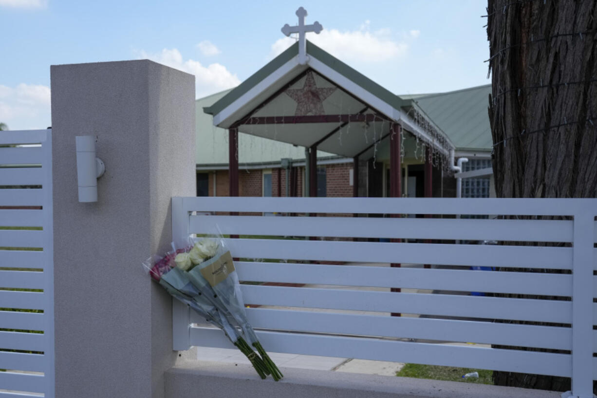 Flowers sit against a fence outside the Christ the Good Shepherd church on Tuesday in Wakely, Australia.