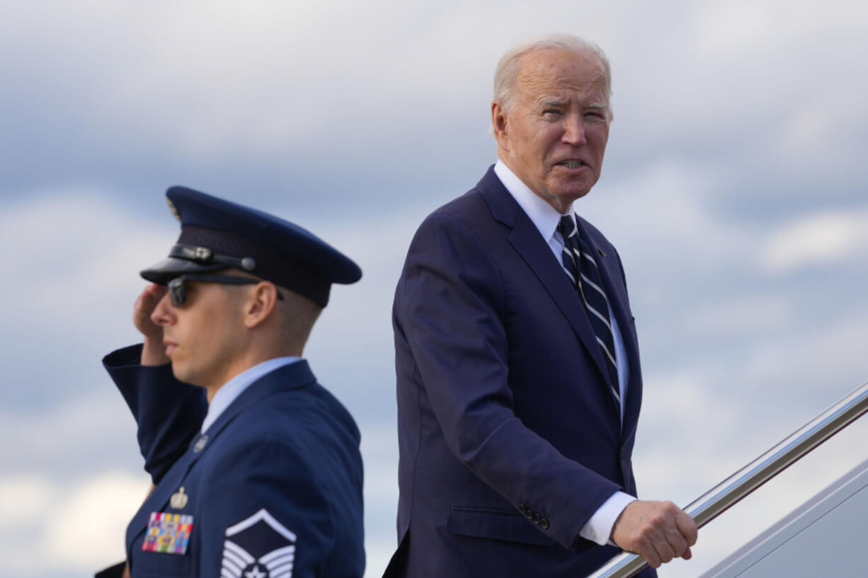 President Joe Biden pauses to respond to a question from a member of the traveling press as he boards Air Force One at Andrews Air Force Base, Md., Friday, April 12, 2024, enroute to New Castle, Del.