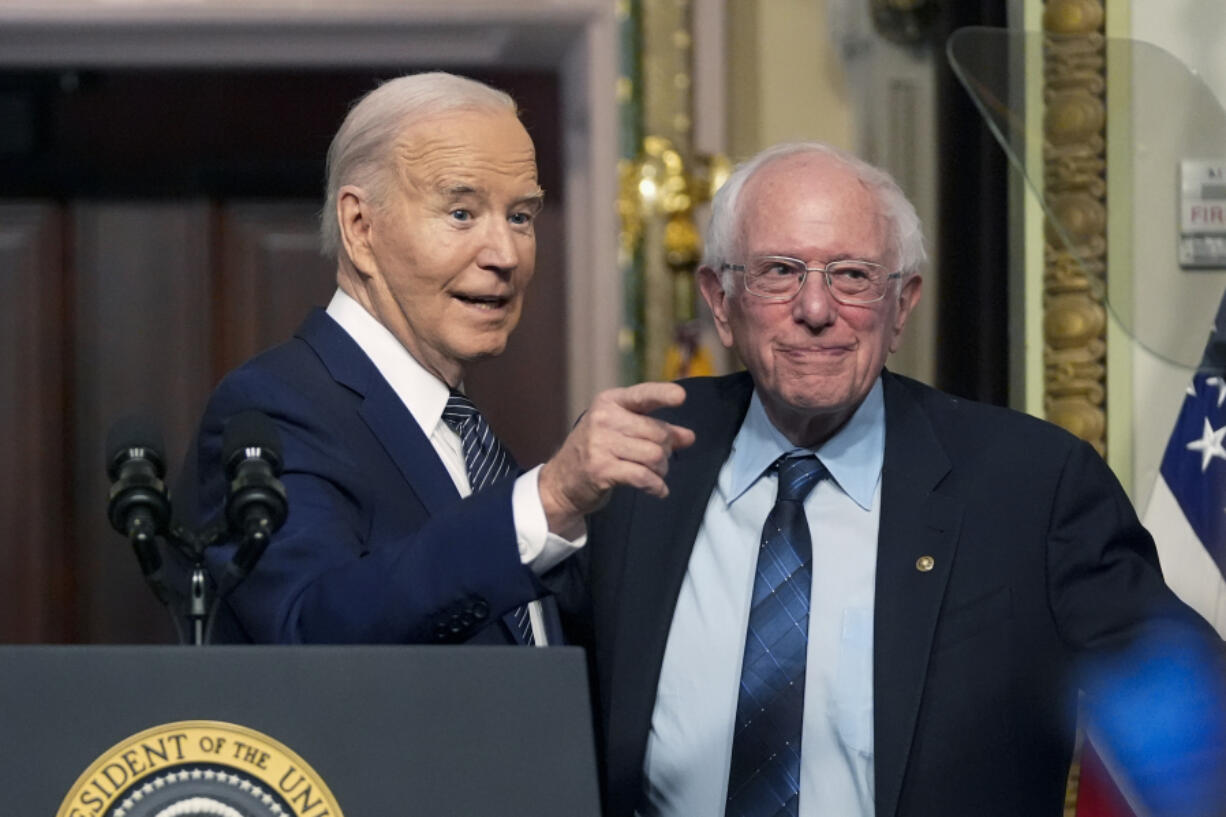 President Joe Biden stands with Sen. Bernie Sanders, I-Vt., after speaking about lowering health care costs in the Indian Treaty Room at the Eisenhower Executive Office Building on the White House complex in Washington, Wednesday, April 3, 2024.
