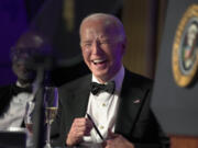 President Joe Biden laughs as host Colin Jost speaks at the White House Correspondents&rsquo; Association Dinner at the Washington Hilton, Saturday, April 27, 2024, in Washington.