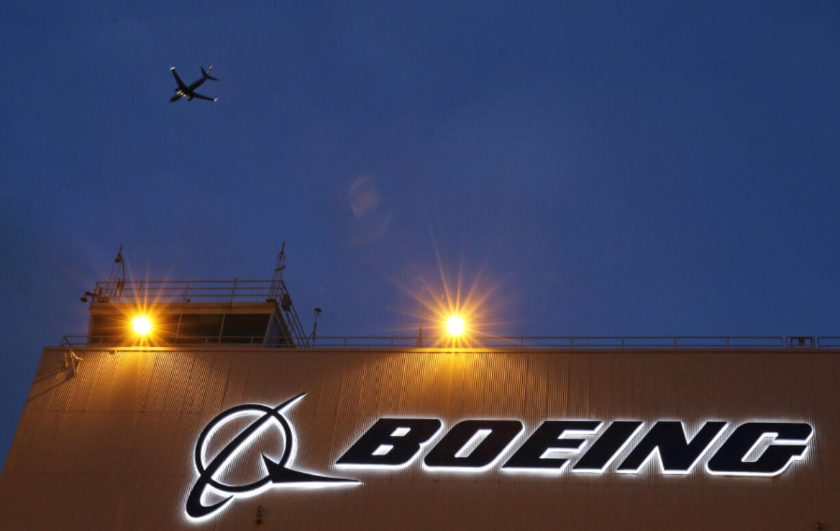 FILE - An airplane flies over a sign on Boeing&rsquo;s 737 delivery center, Oct. 19, 2015, at Boeing Field in Seattle. The Federal Aviation Administration says a Southwest Airlines jet leaving Denver was forced to land after the engine cover fell off and struck the wing flap during takeoff. Southwest Airlines says the Boeing 737 landed safely Sunday, April 7, 2024, and the passengers headed to Houston are being put onto another aircraft.  (AP Photo/Ted S.