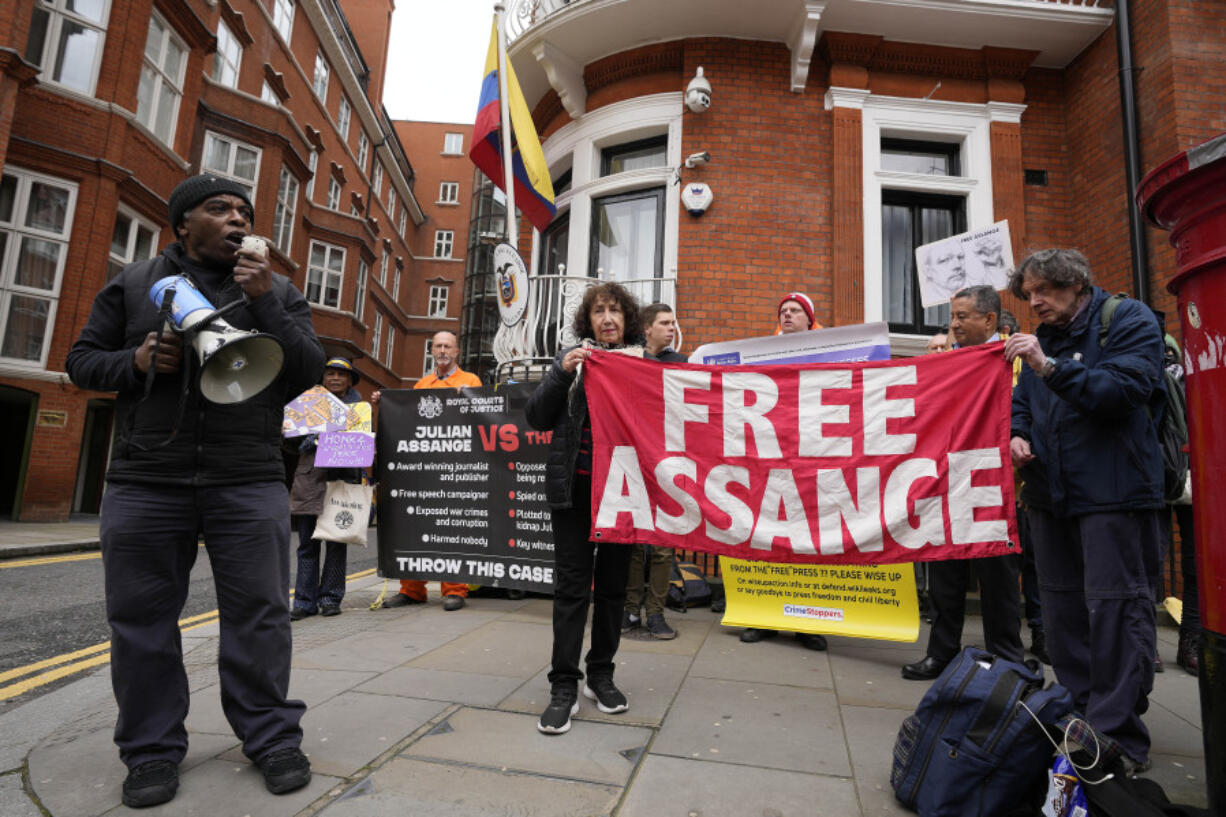 Protesters stand in front of the Ecuadorian Embassy  in London, Thursday, April 11, 2024, where Wikileaks founder Julian Assange was arrested five years ago. US President Joe Biden said Wednesday that he is considering a request from Australia to drop the decade-long U.S.