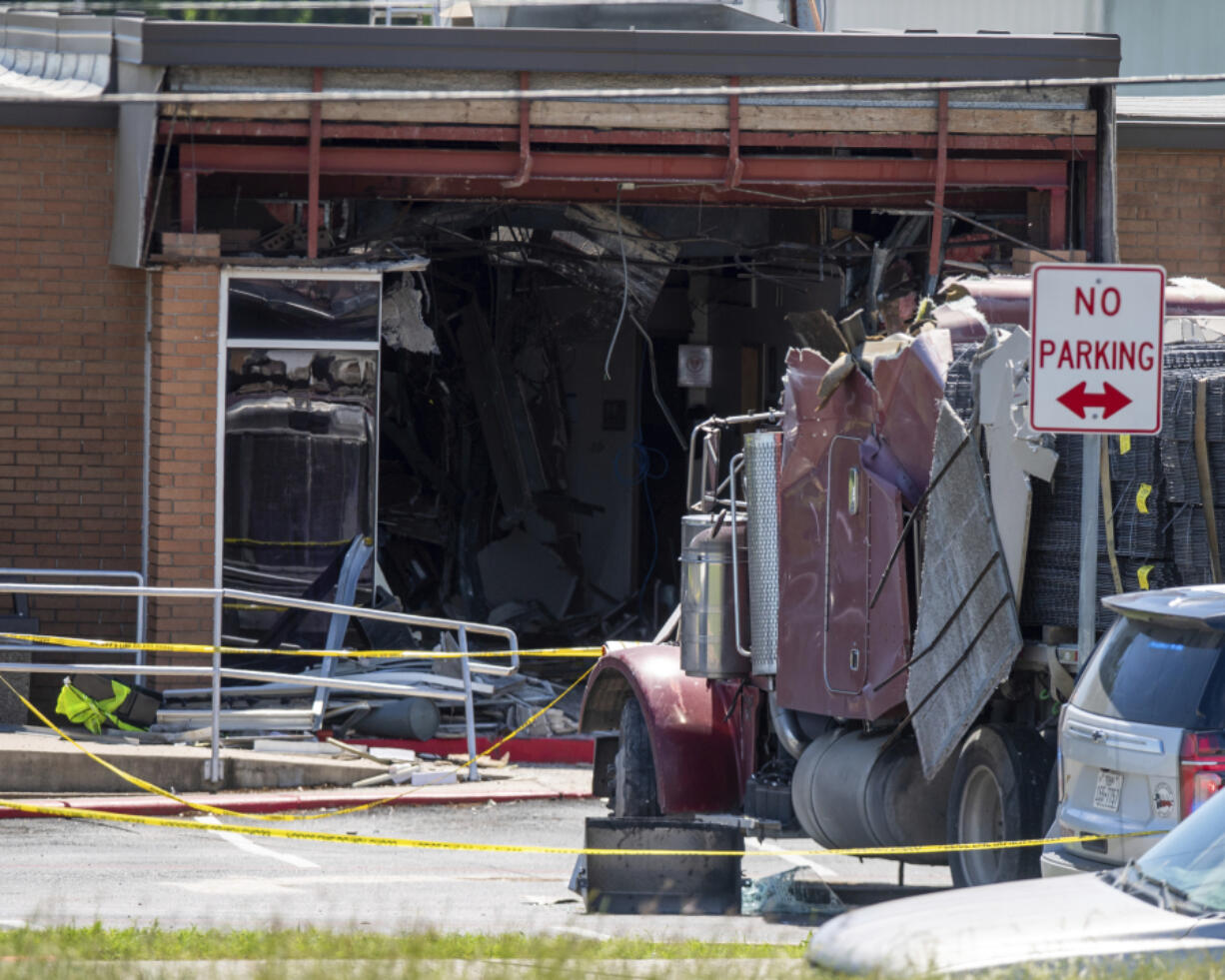 A stolen 18-wheeler crashed into a Texas Department of Public Safety office on US-290 in Brenham, Texas on Friday, April 12, 2024.  The driver of a stolen semitrailer intentionally rammed it into the Texas public safety office in a rural town west of Houston on Friday, injuring multiple people, according to a state lawmaker.