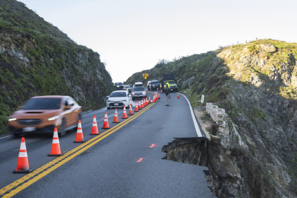 Cars drive north out of Big Sur during a morning caravan past a break in the southbound lane of Highway 1 at Rocky Creek Bridge in Big Sur, Calif., Monday, April 1, 2024.