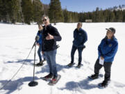 Gov. Gavin Newsom announces an updated California Water Plan with Department of Water Resources director Karla Nemeth, left, Natural Resources Secretary Wade Crowfoot, center, and DWR water resources engineer Andrew Reising during the April snow survey at Phillips Station in El Dorado County on Tuesday, April 2, 2024.